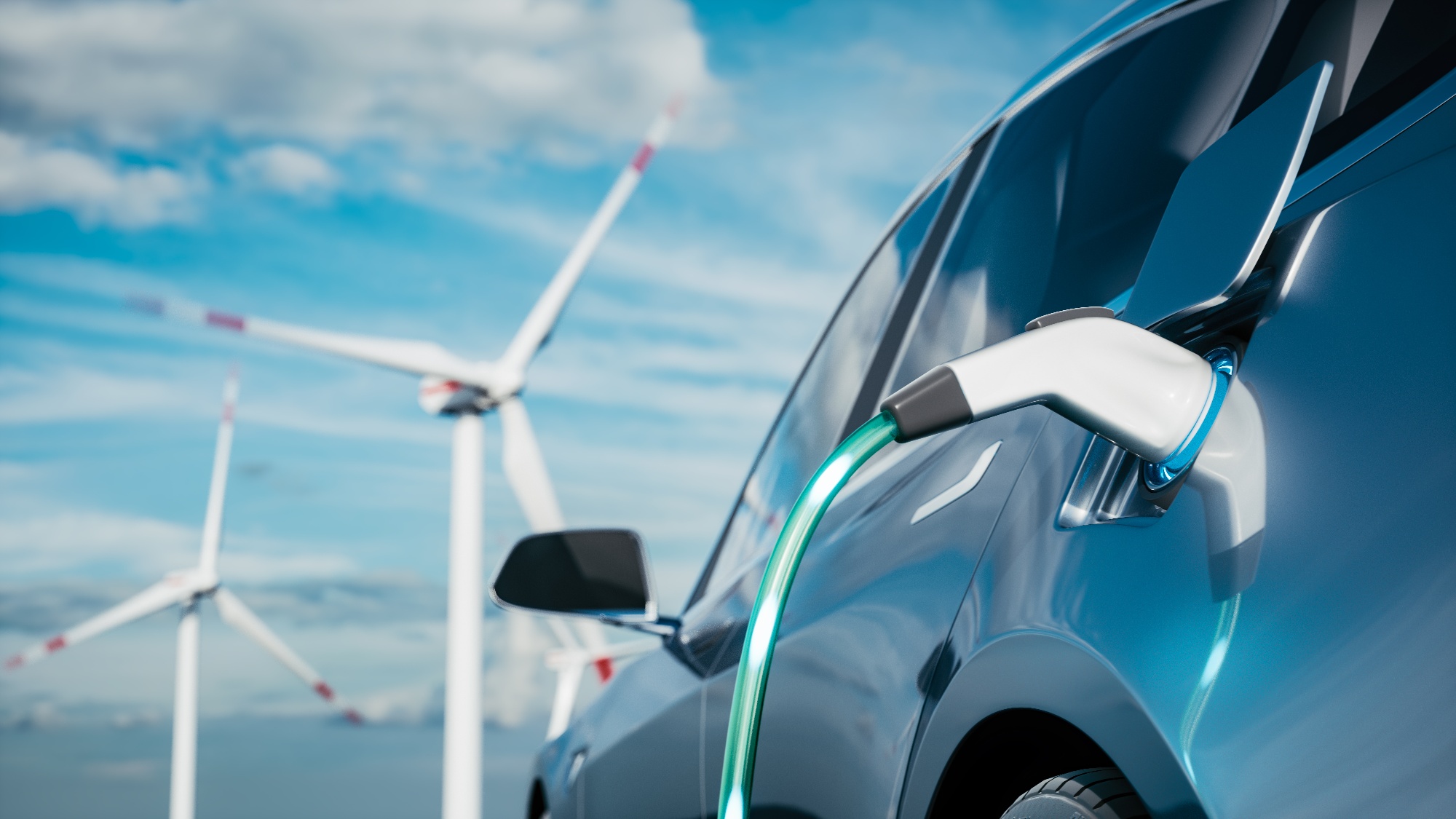 Electric car charging with wind turbines in background